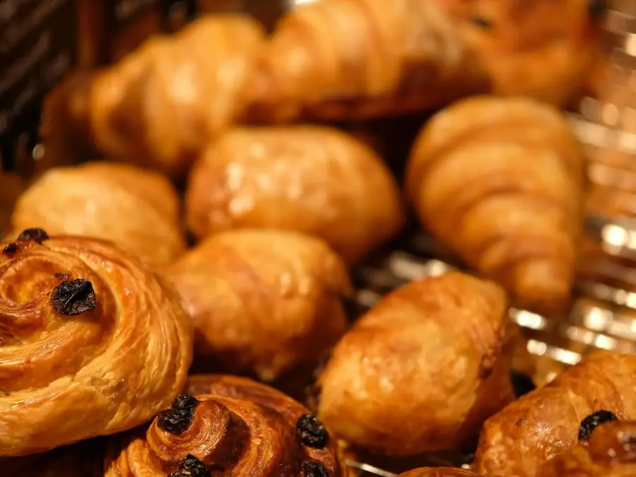 Freshly baked croissants and chocolate pastries piled together