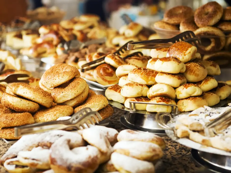 A breakfast buffet of pastries, bagels and Danishes on tiered trays