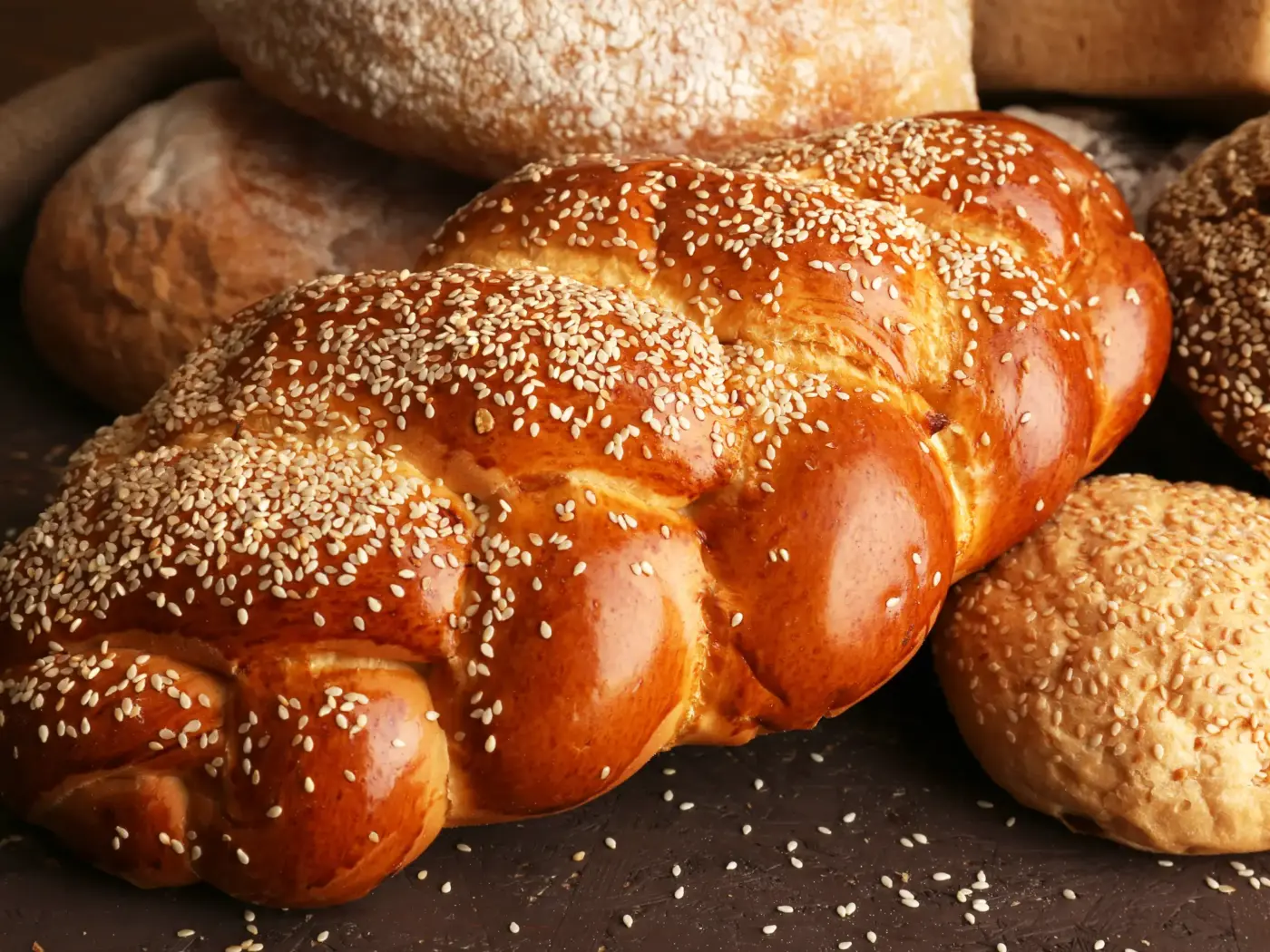 A braided challah loaf topped with sesame seeds