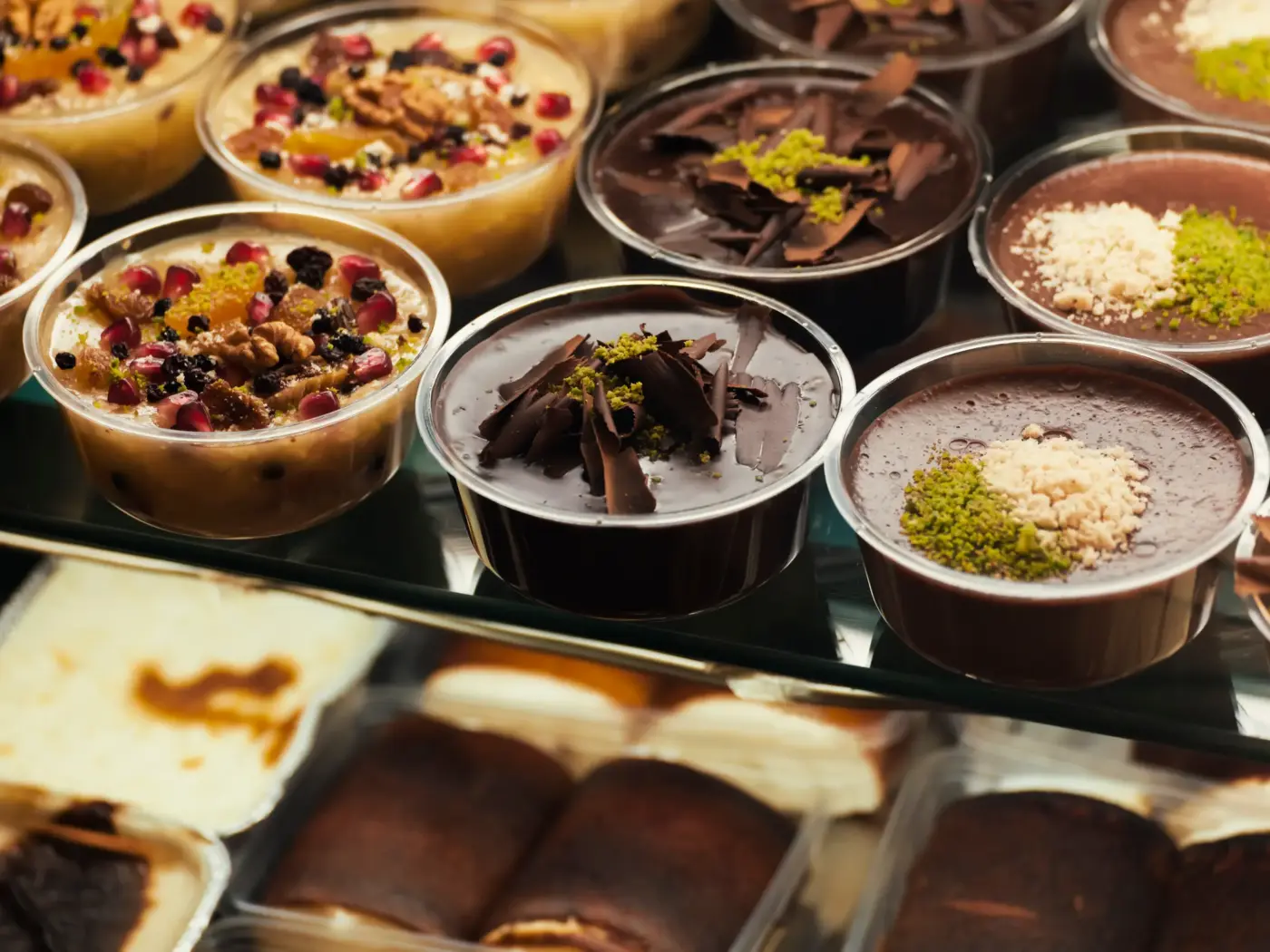 Individual mousse and pudding desserts in small cups