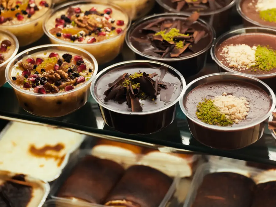 Individual mousse and pudding desserts in small cups