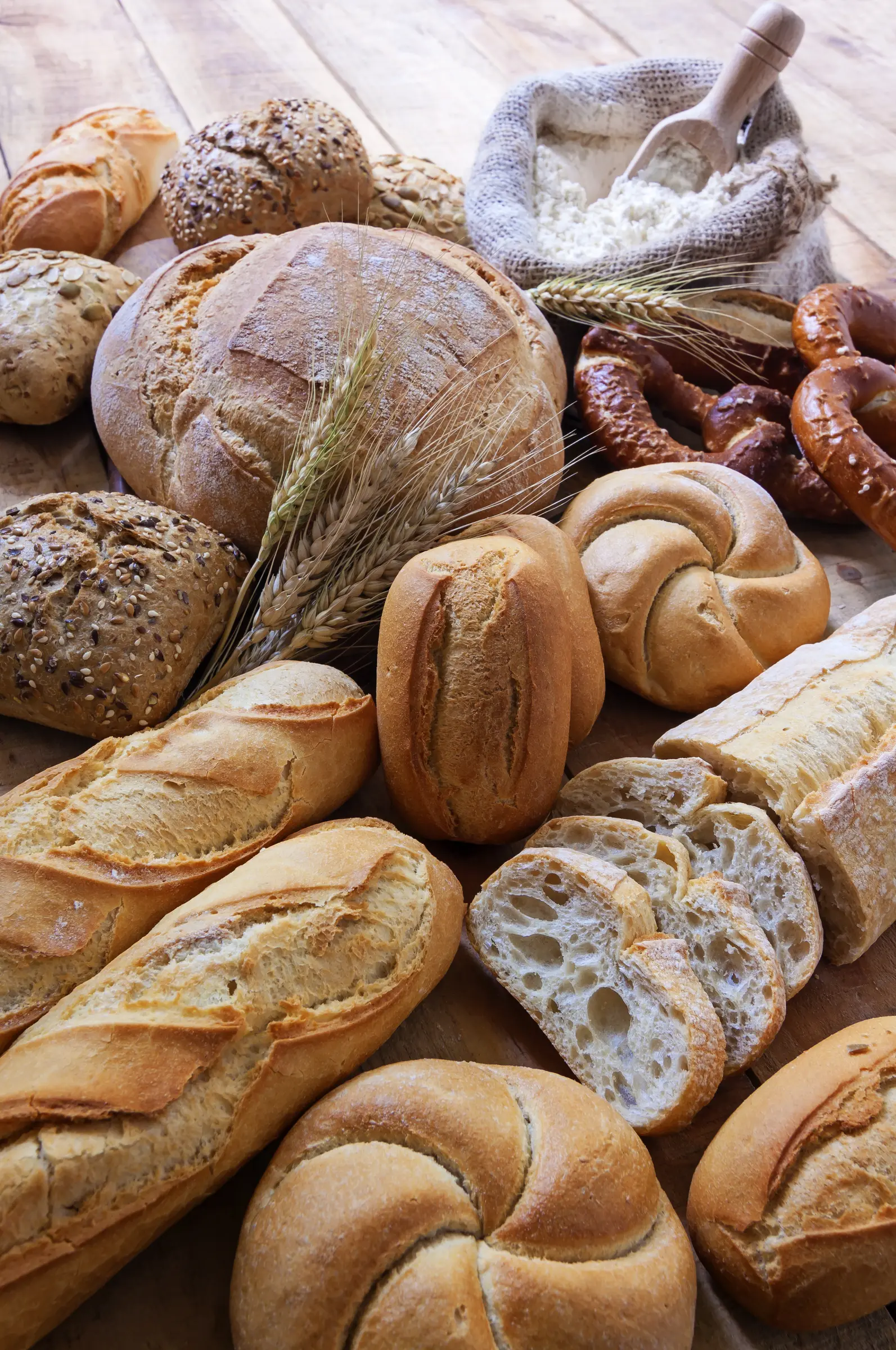Rustic artisan loaves and baguettes with stalks of wheat