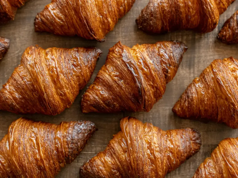 Freshly baked butter croissants on a wood surface