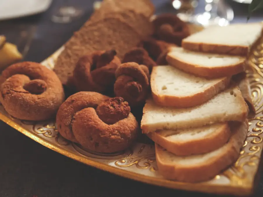 Sliced pound cake and ring doughnuts on a gold plate